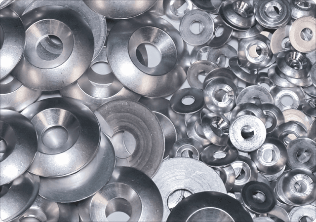 A pile of decorative washers designed and manufactured by Harper Engineering Co.